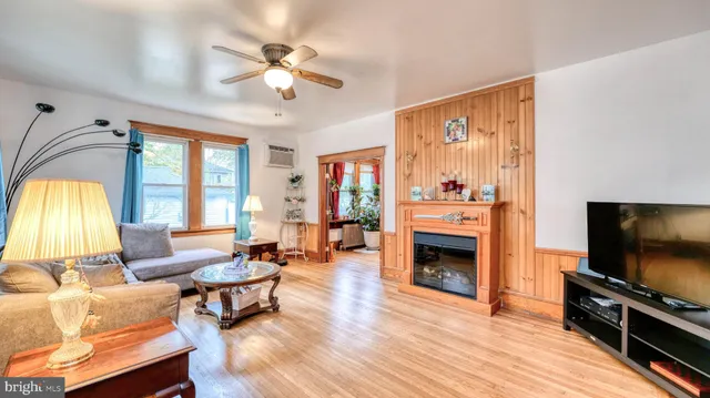 a living room with furniture a flat screen tv and a fireplace