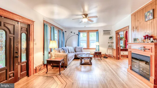 a living room with furniture and a chandelier