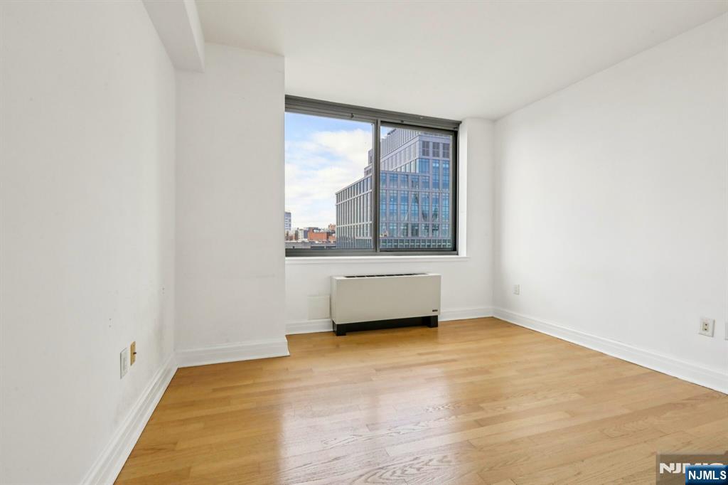 1 Spring Street, Unit 1004 New Brunswick, NJ 08901 - Photo 16 of 26 an empty room with a window