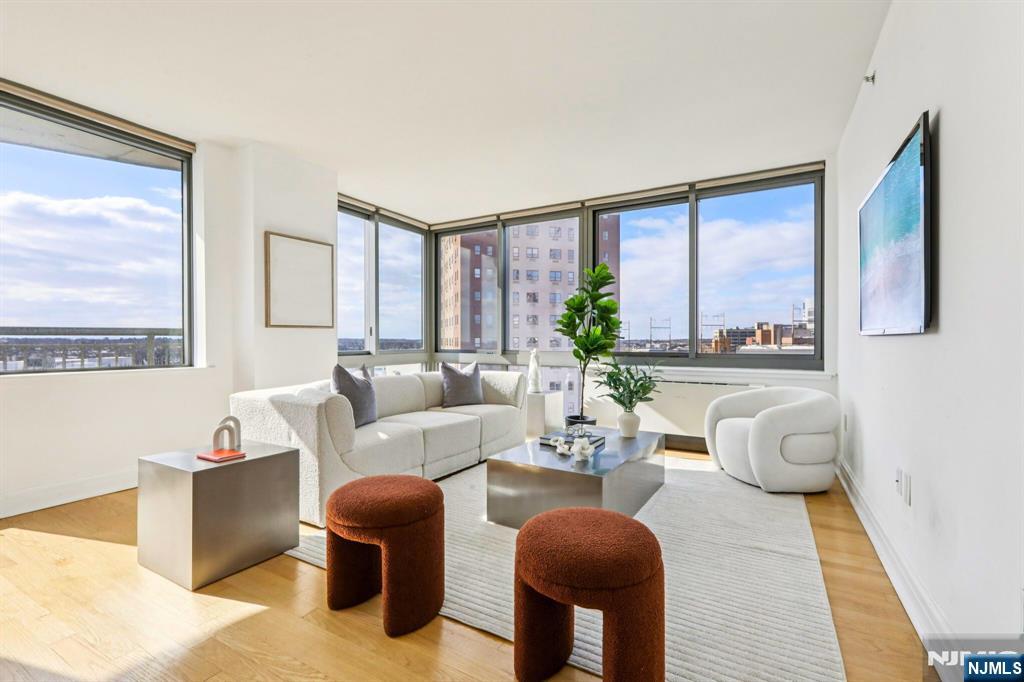 1 Spring Street, Unit 1004 New Brunswick, NJ 08901 - Photo 5 of 26 a living room with furniture and a large window
