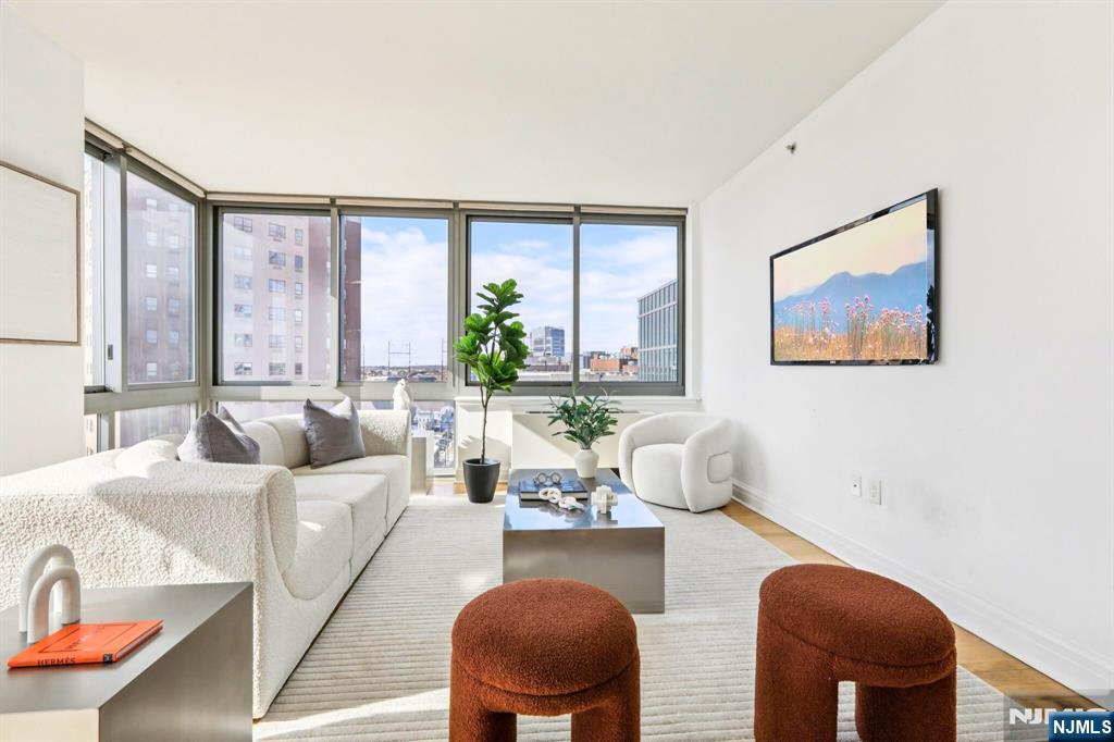 1 Spring Street, Unit 1004 New Brunswick, NJ 08901 - Photo 6 of 26 a living room with furniture and a large window