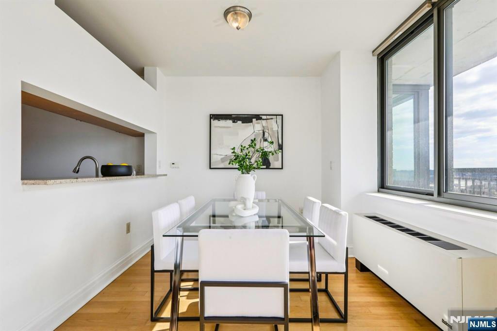 1 Spring Street, Unit 1004 New Brunswick, NJ 08901 - Photo 9 of 26 a living room with furniture and a wooden floor