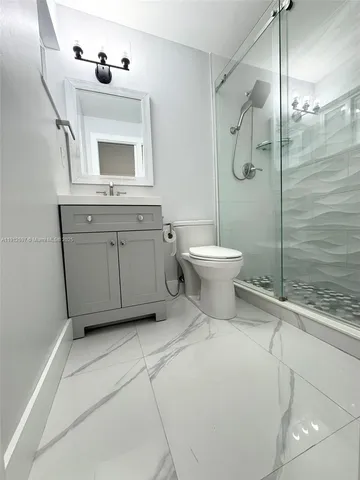 a bathroom with a toilet sink and shower