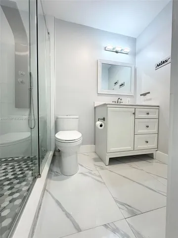 a bathroom with a sink toilet and shower