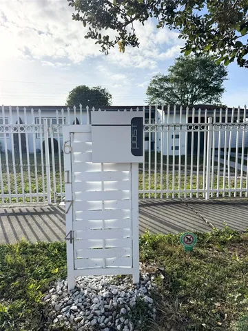 a view of a pathway with a small yard