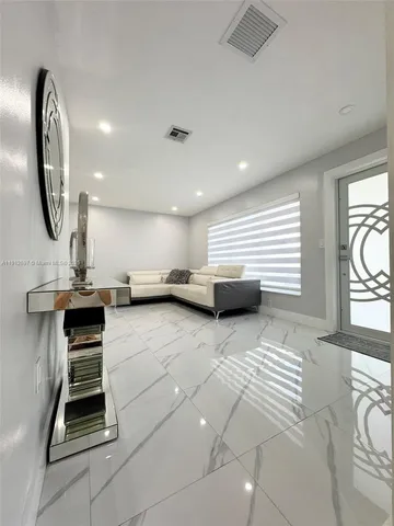 a view of a livingroom with furniture and a large window