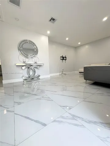 a bathroom with a bathtub and mirror