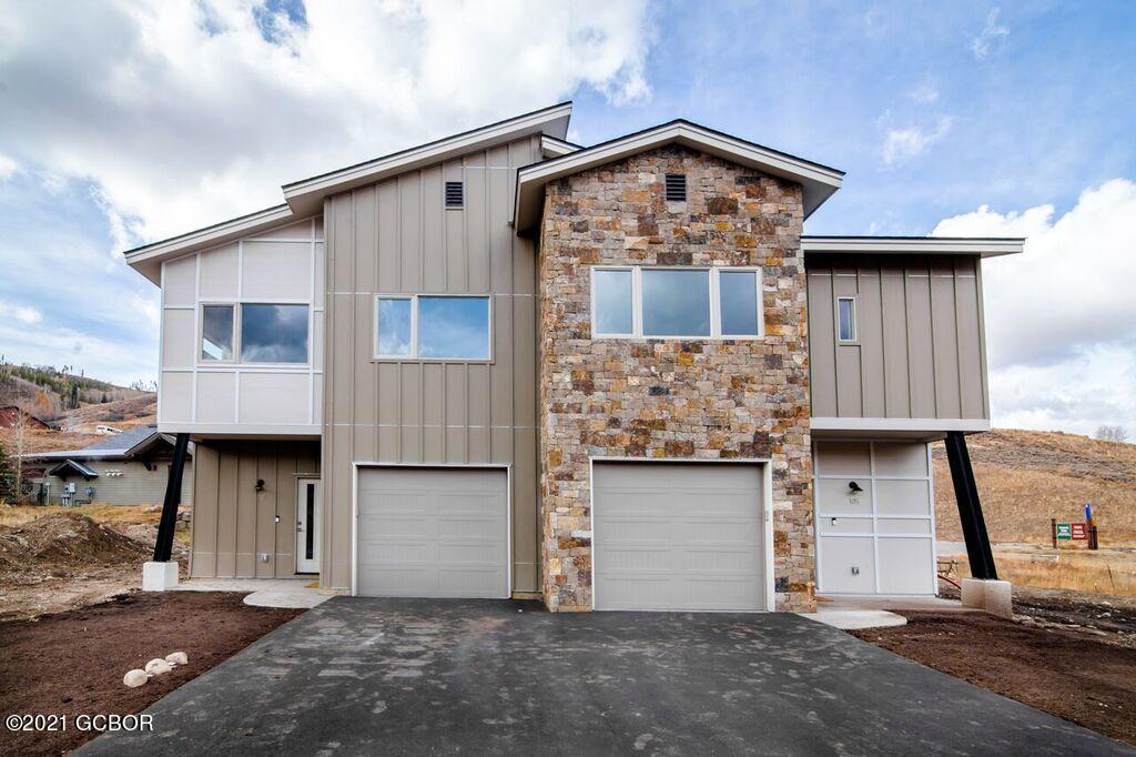 a front view of a house with a garage