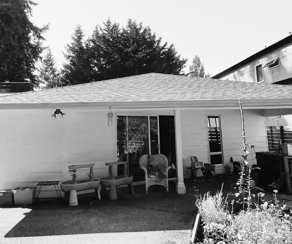 a view of a patio with couches table and chairs and potted plants