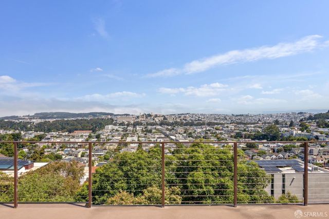 an aerial view of residential building and trees around