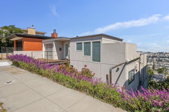a front view of a house with a yard and a fence