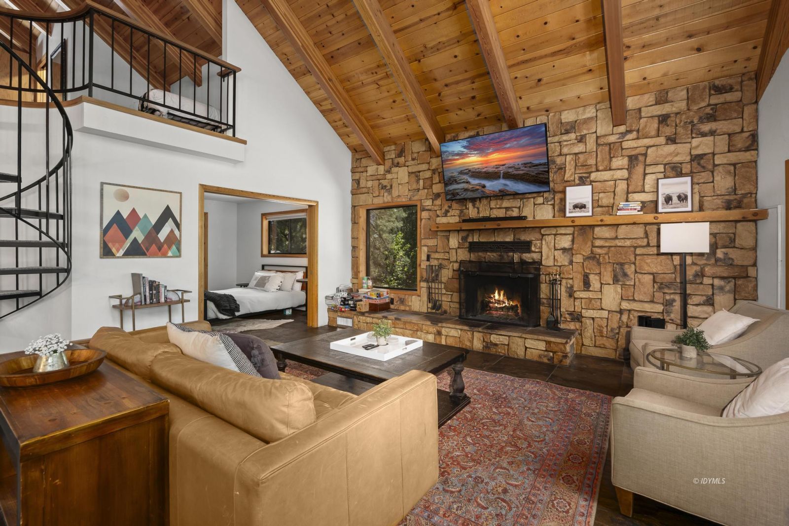 24747 Fern Valley Road Idyllwild, CA 92549 - Photo 14 of 42 a living room with furniture a flat screen tv and a fireplace