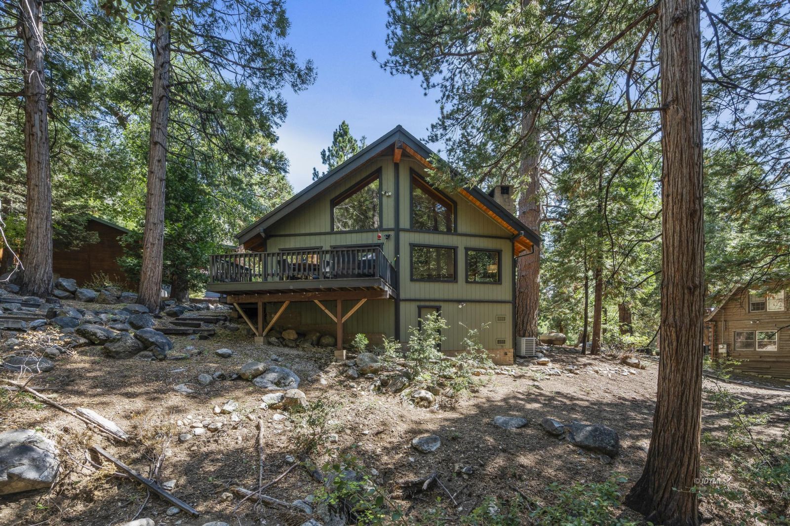 24747 Fern Valley Road Idyllwild, CA 92549 - Photo 2 of 42 a view of a wooden house with a yard and large trees