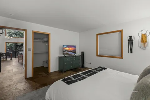 a bedroom with a bed and a tv