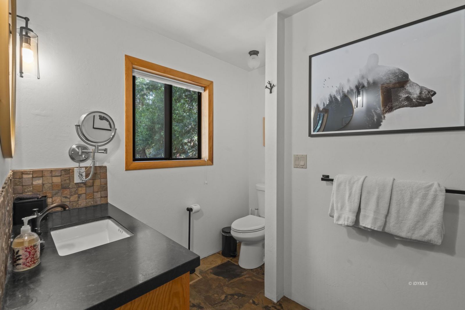 24747 Fern Valley Road Idyllwild, CA 92549 - Photo 27 of 42 a bathroom with a toilet a sink and mirror