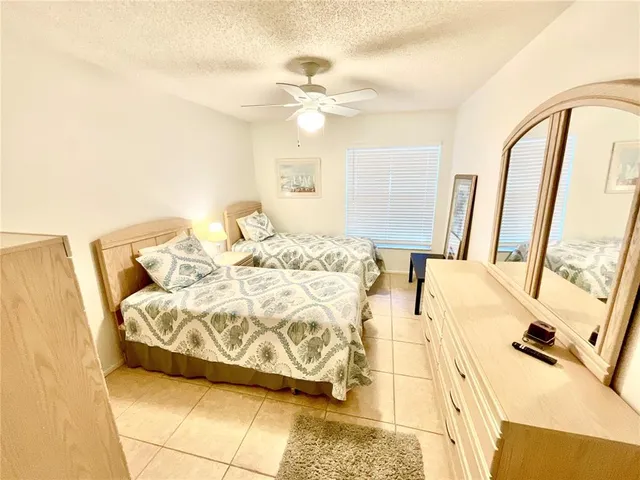 a bedroom with a bed and a mirror