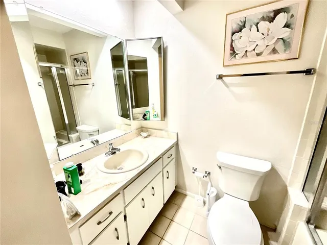 a bathroom with a sink mirror vanity and toilet