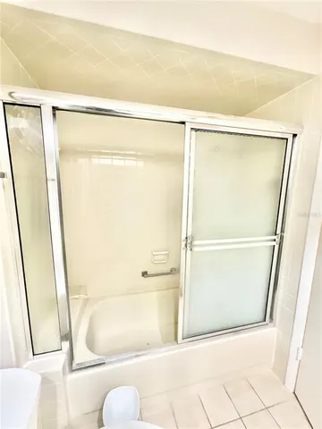 a bathroom with a shower and a tub