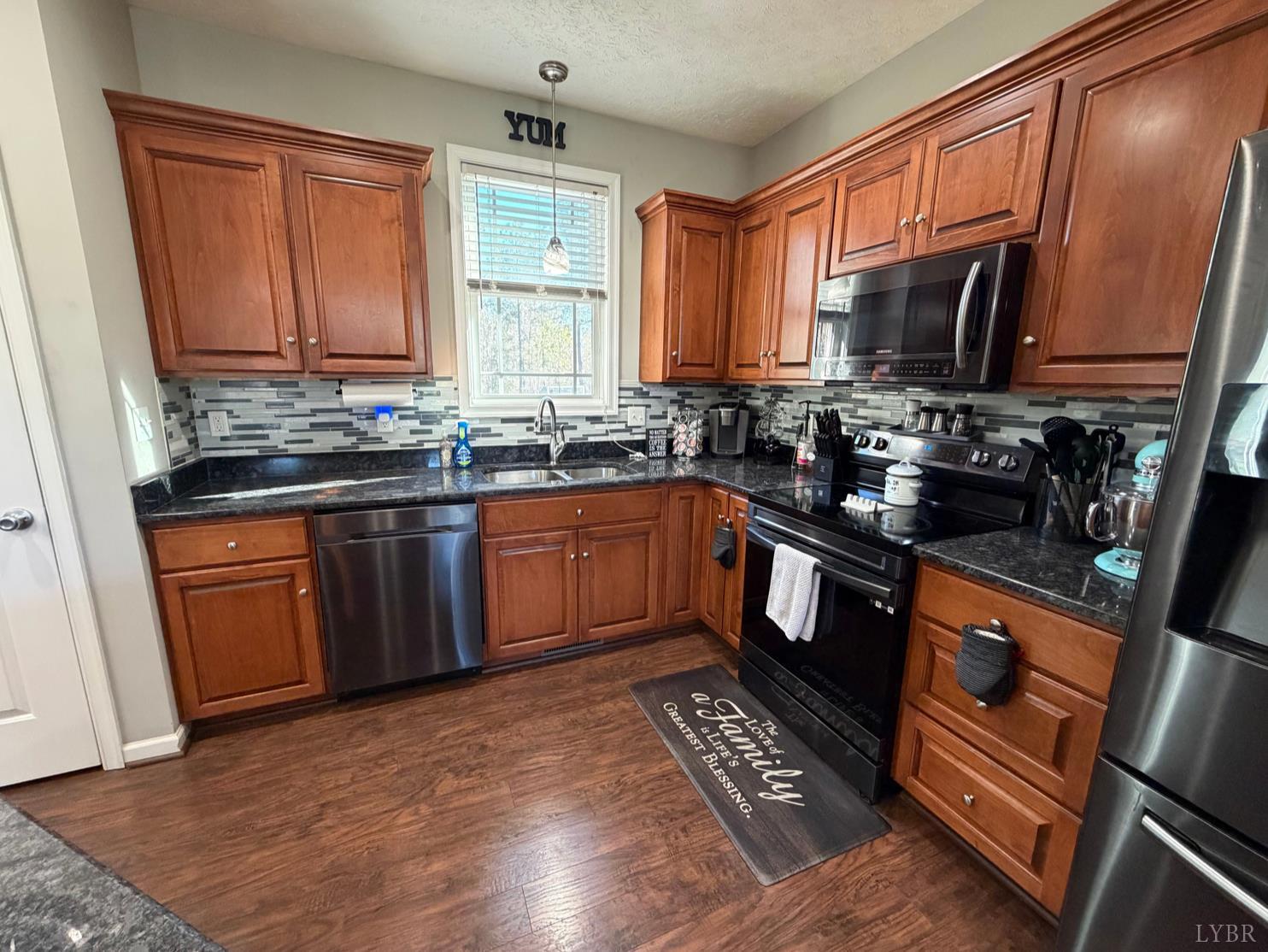 271 Pleasant Ridge Drive Madison Heights, VA 24572 - Photo 13 of 52 a kitchen with stainless steel appliances granite countertop a sink stove and refrigerator