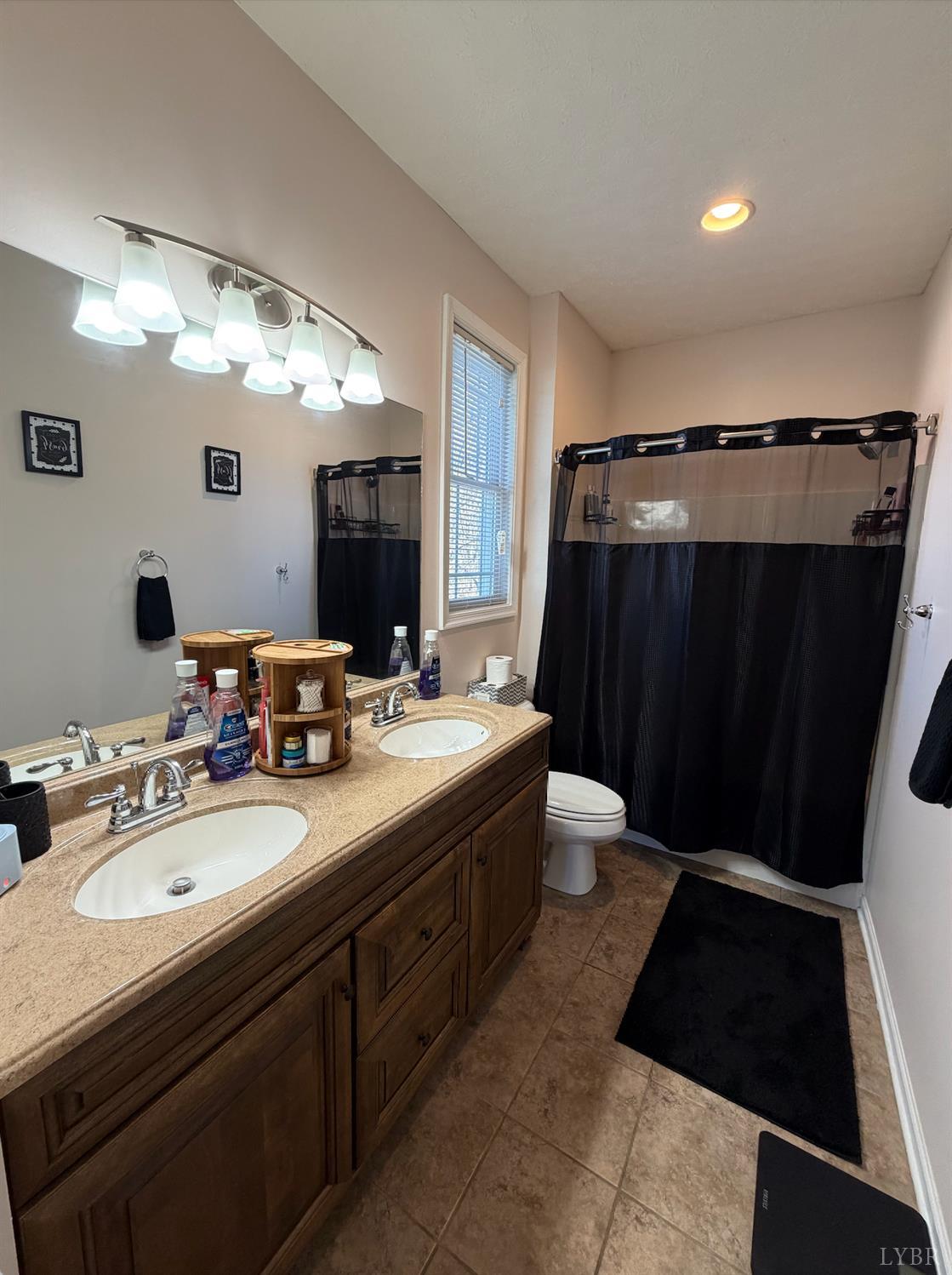 271 Pleasant Ridge Drive Madison Heights, VA 24572 - Photo 17 of 52 a bathroom with a double vanity sink and mirror