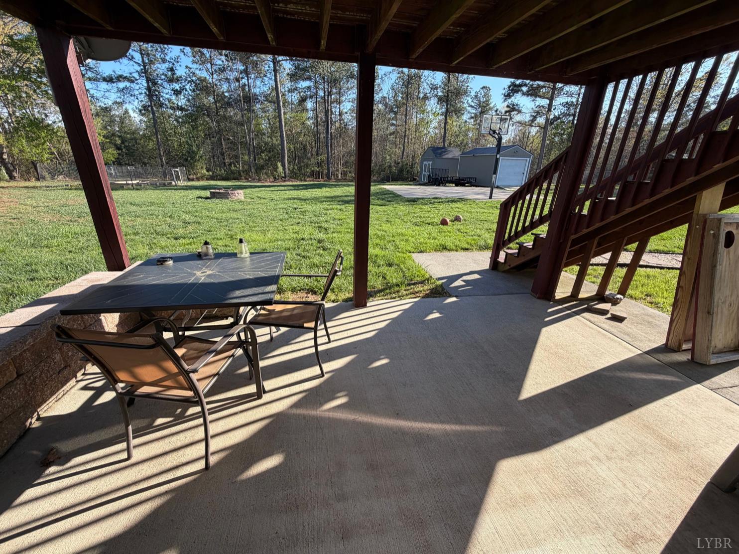 271 Pleasant Ridge Drive Madison Heights, VA 24572 - Photo 35 of 52 a view of a patio with a table chairs and a backyard
