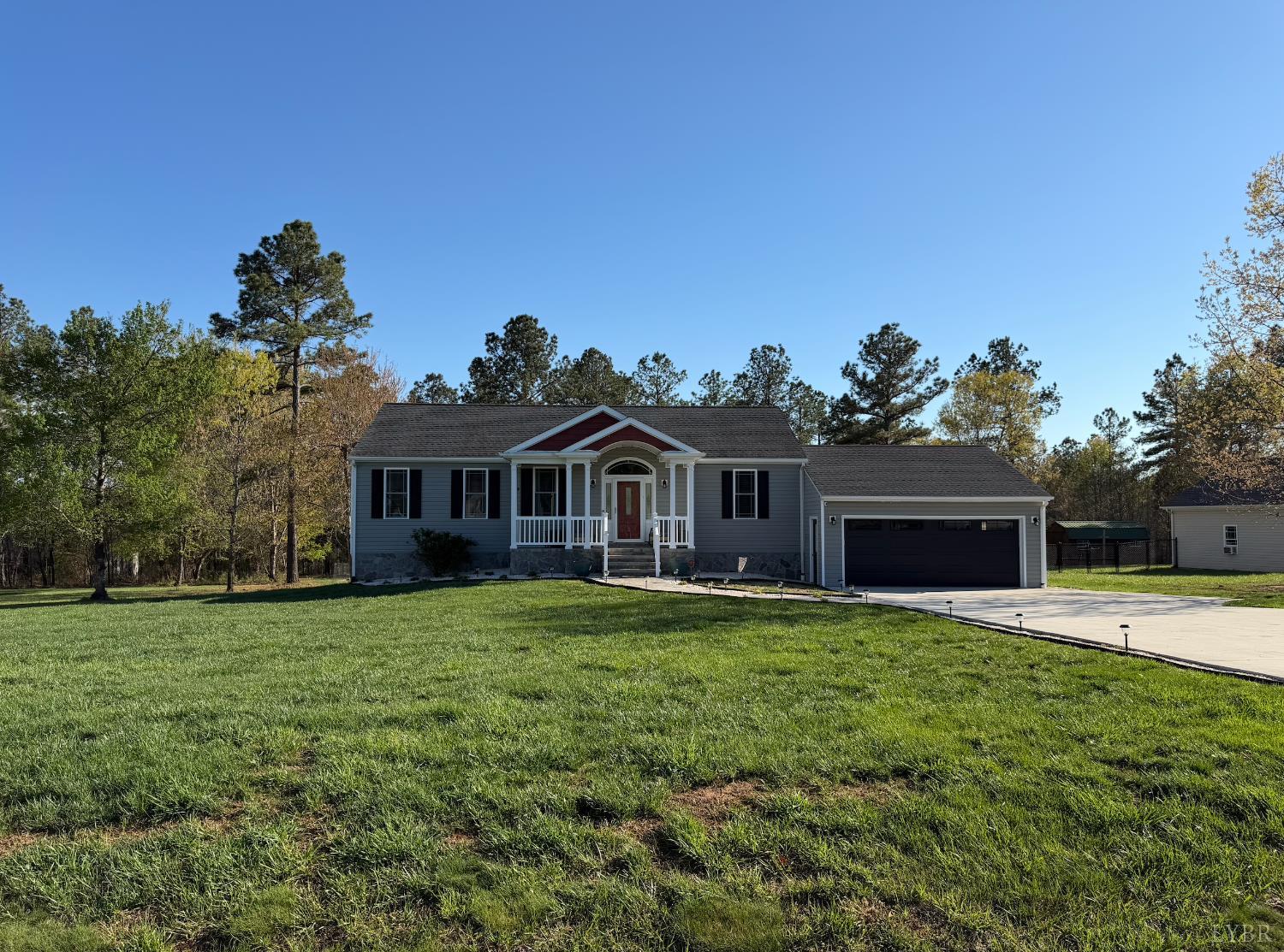 271 Pleasant Ridge Drive Madison Heights, VA 24572 - Photo 50 of 52 a front view of a house with a garden and trees