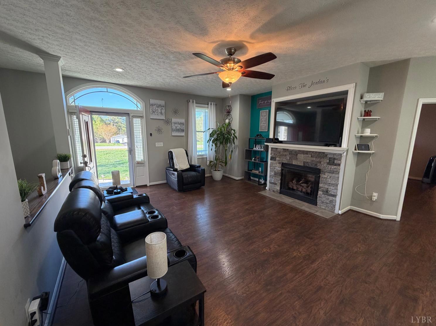 271 Pleasant Ridge Drive Madison Heights, VA 24572 - Photo 8 of 52 a living room with furniture a fireplace and a flat screen tv