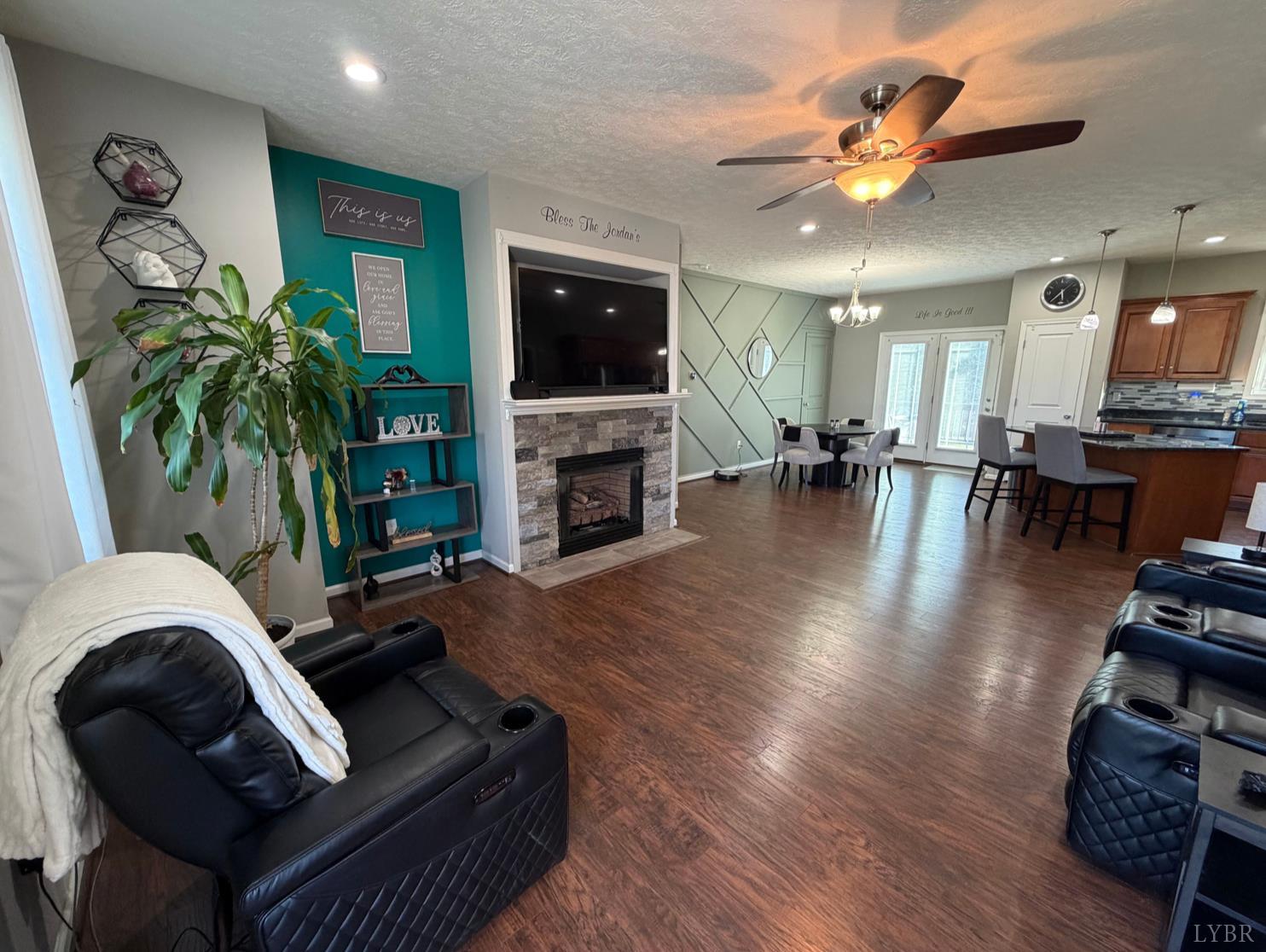 271 Pleasant Ridge Drive Madison Heights, VA 24572 - Photo 10 of 52 a living room with furniture a flat screen tv and a fireplace