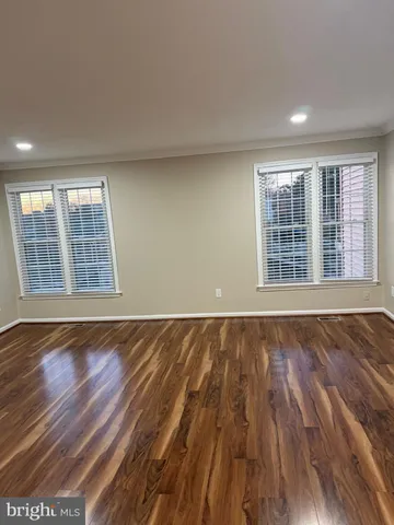 a view of a room with wooden floor and window