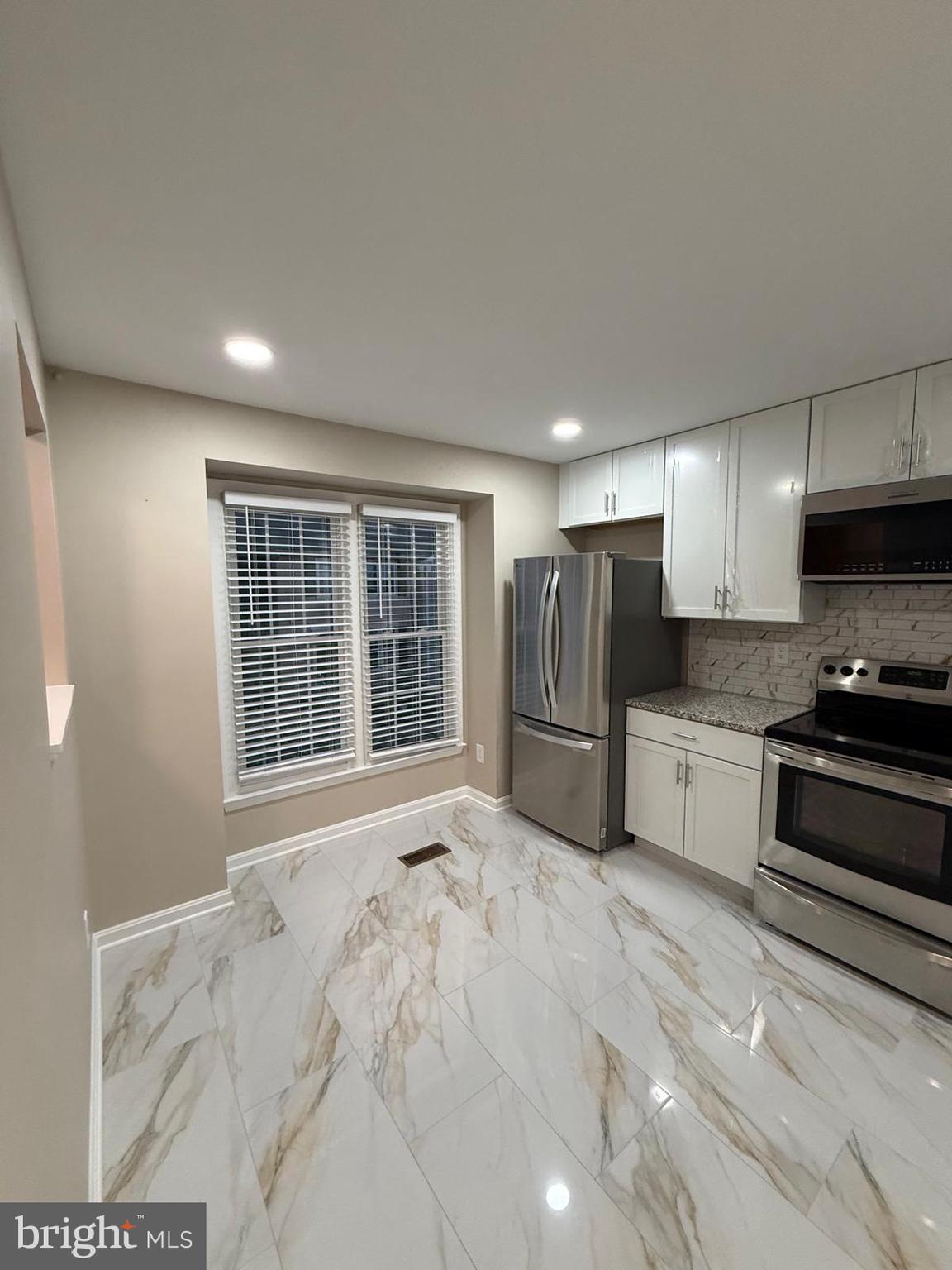 45 Fendall Avenue Alexandria, VA 22304 - Photo 13 of 45 a large kitchen with stainless steel appliances granite countertop a stove a sink and a refrigerator