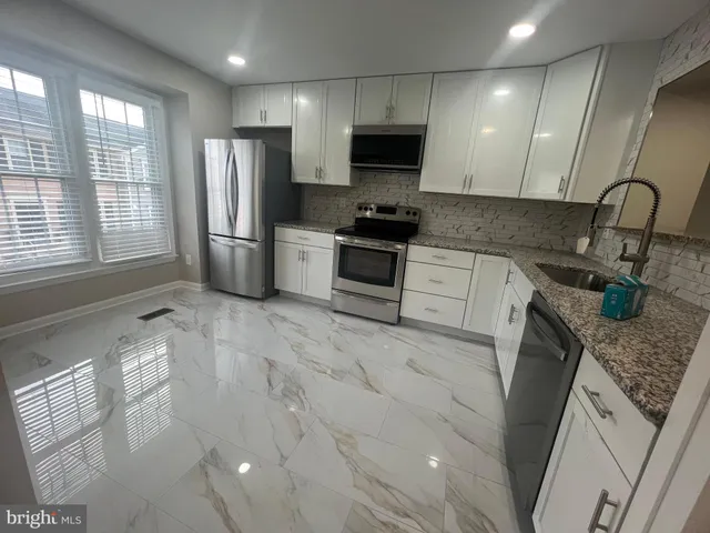 a view of a room with wooden floor and windows