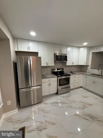 a bathroom with a granite countertop toilet a sink and a bathtub
