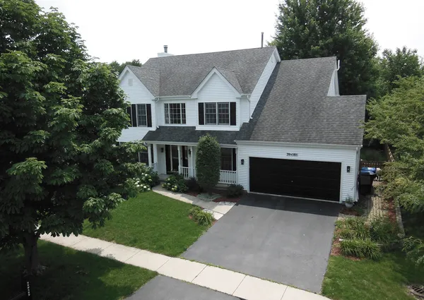 a aerial view of a house with a yard and potted plants