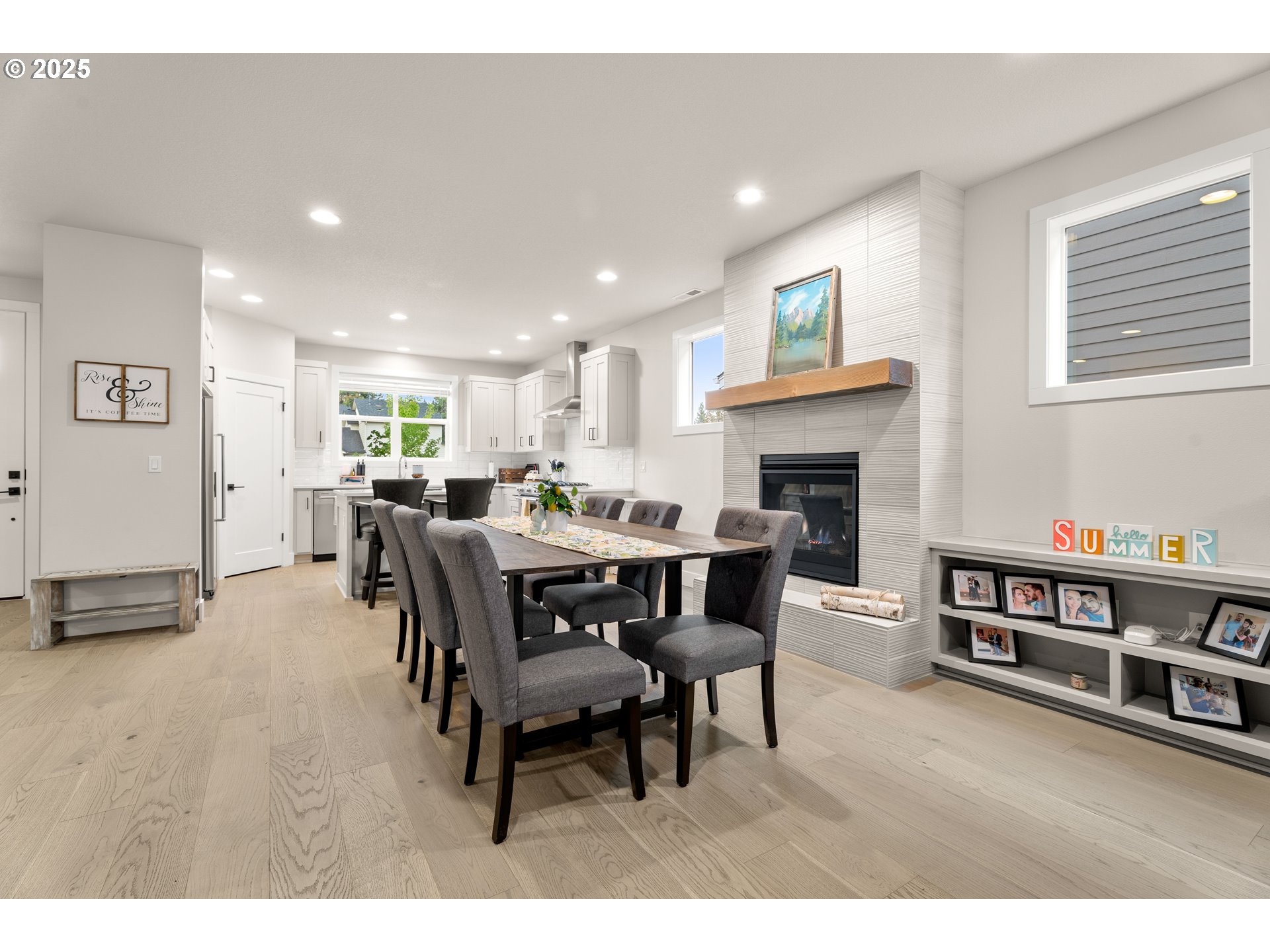 20211 Glen Vista Road Bend, OR 97703 - Photo 11 of 32 a living room with furniture a fireplace and a kitchen view