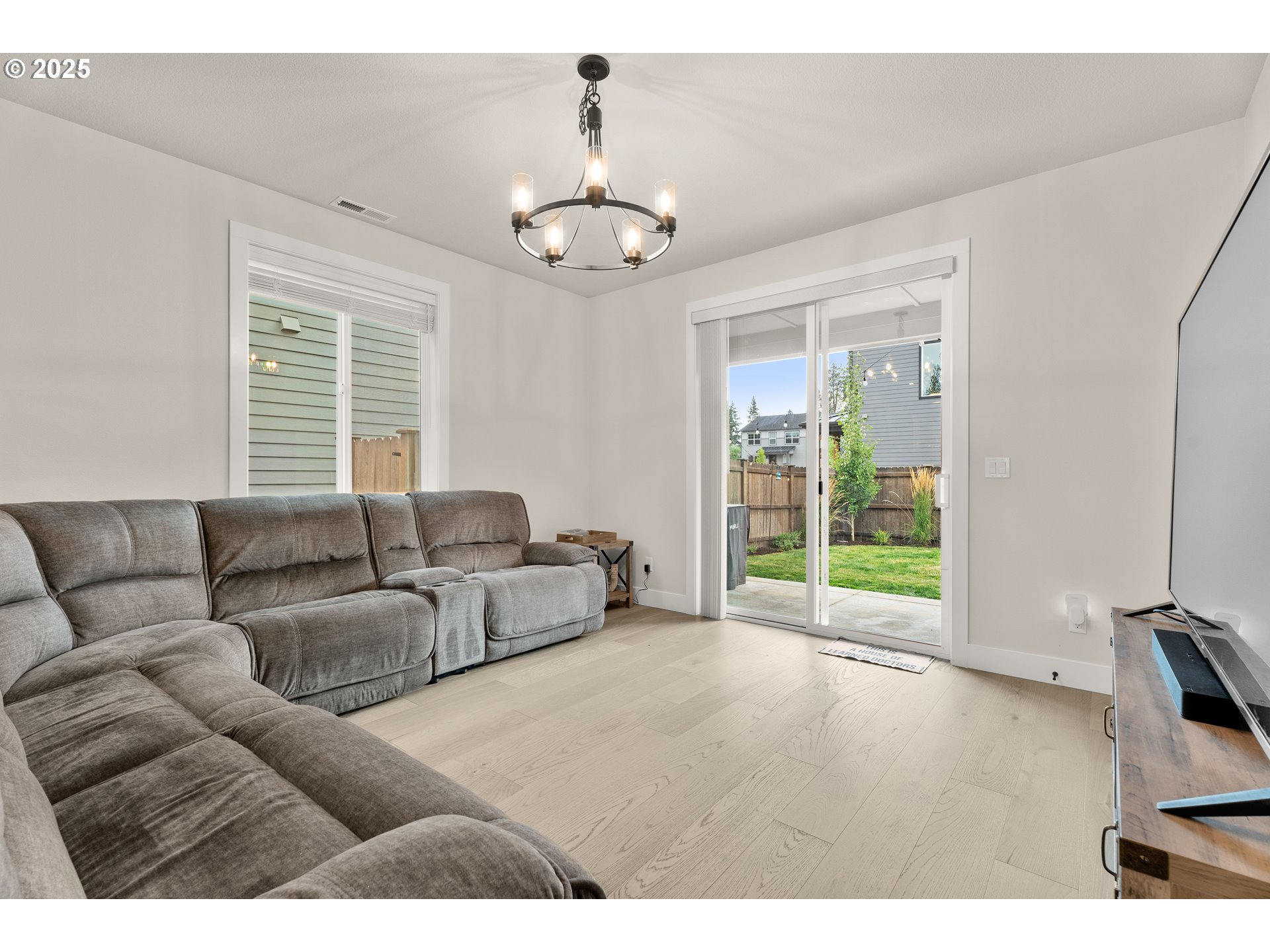 20211 Glen Vista Road Bend, OR 97703 - Photo 13 of 32 a living room with furniture and a chandelier