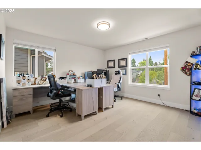 a view of a livingroom with workspace and a window