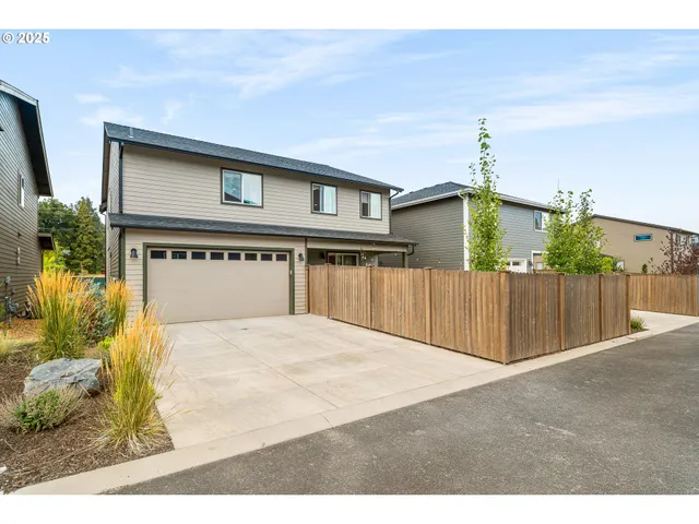 a front view of house with wooden fence