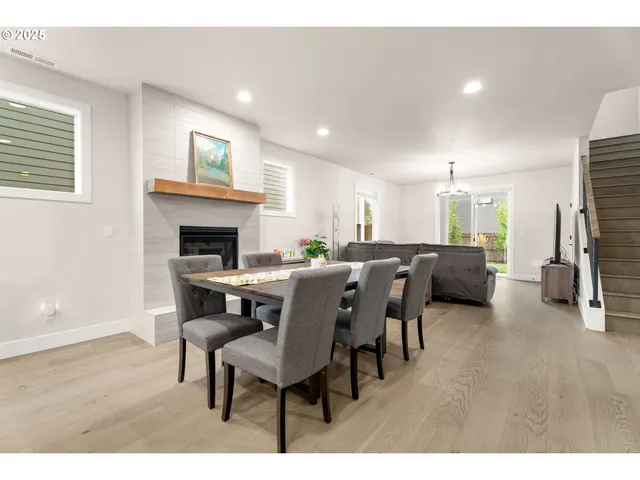 a living room with furniture a fireplace and a kitchen view
