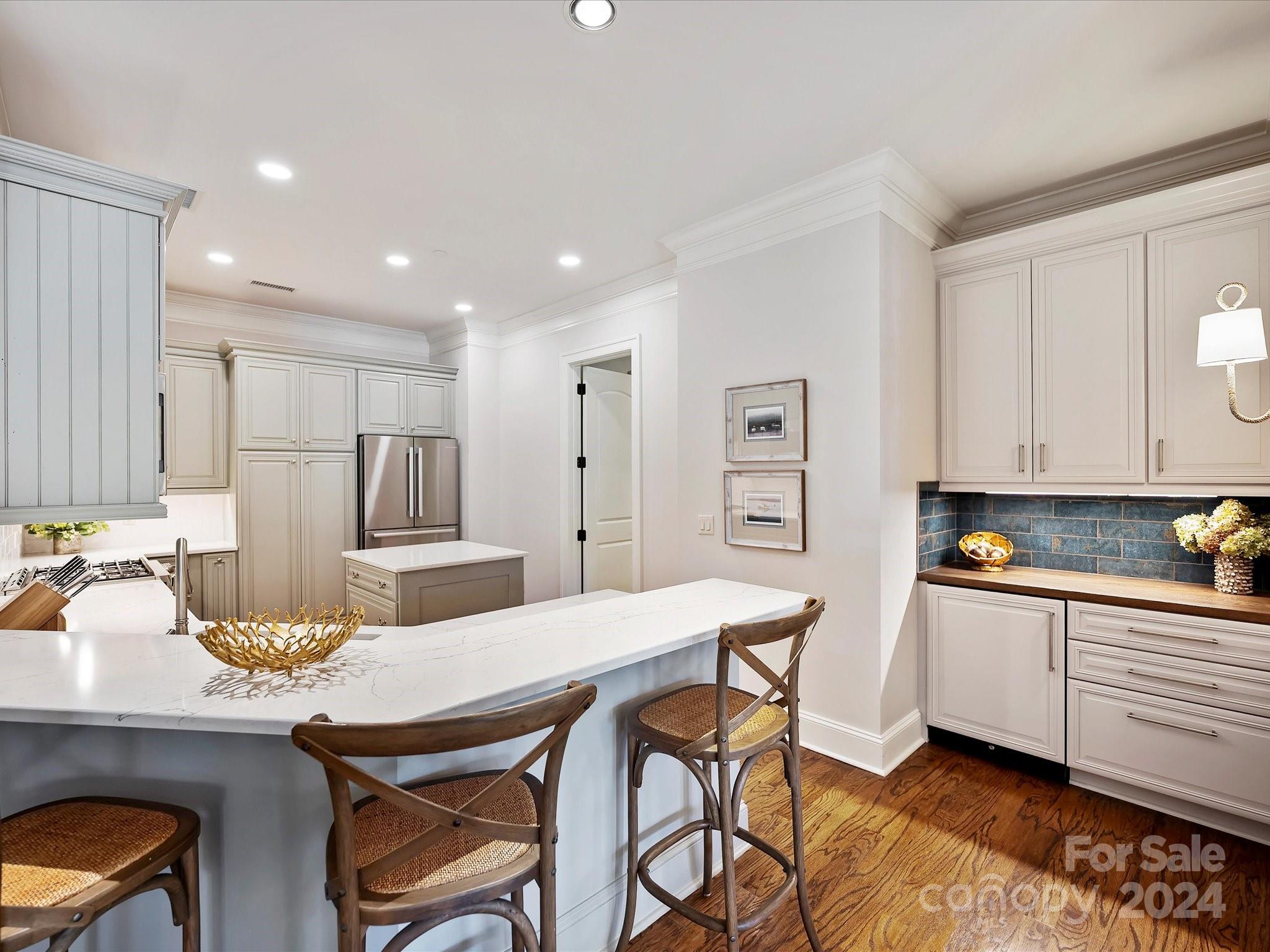 2823 Providence Road, Unit 216 Charlotte, NC 28211 - Photo 11 of 35 a kitchen with a table chairs refrigerator and cabinets