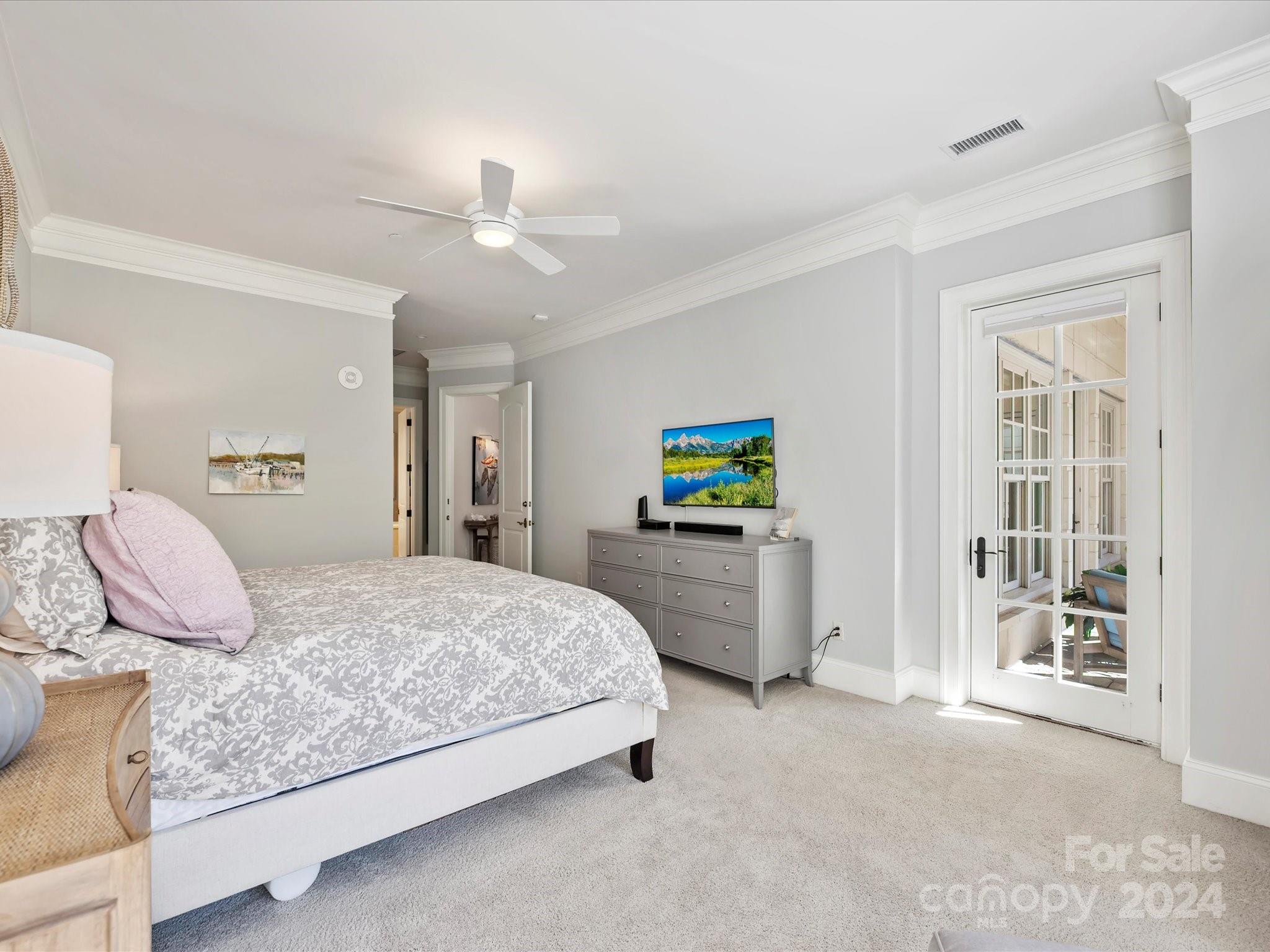 2823 Providence Road, Unit 216 Charlotte, NC 28211 - Photo 20 of 35 a bedroom with a bed and ceiling fan