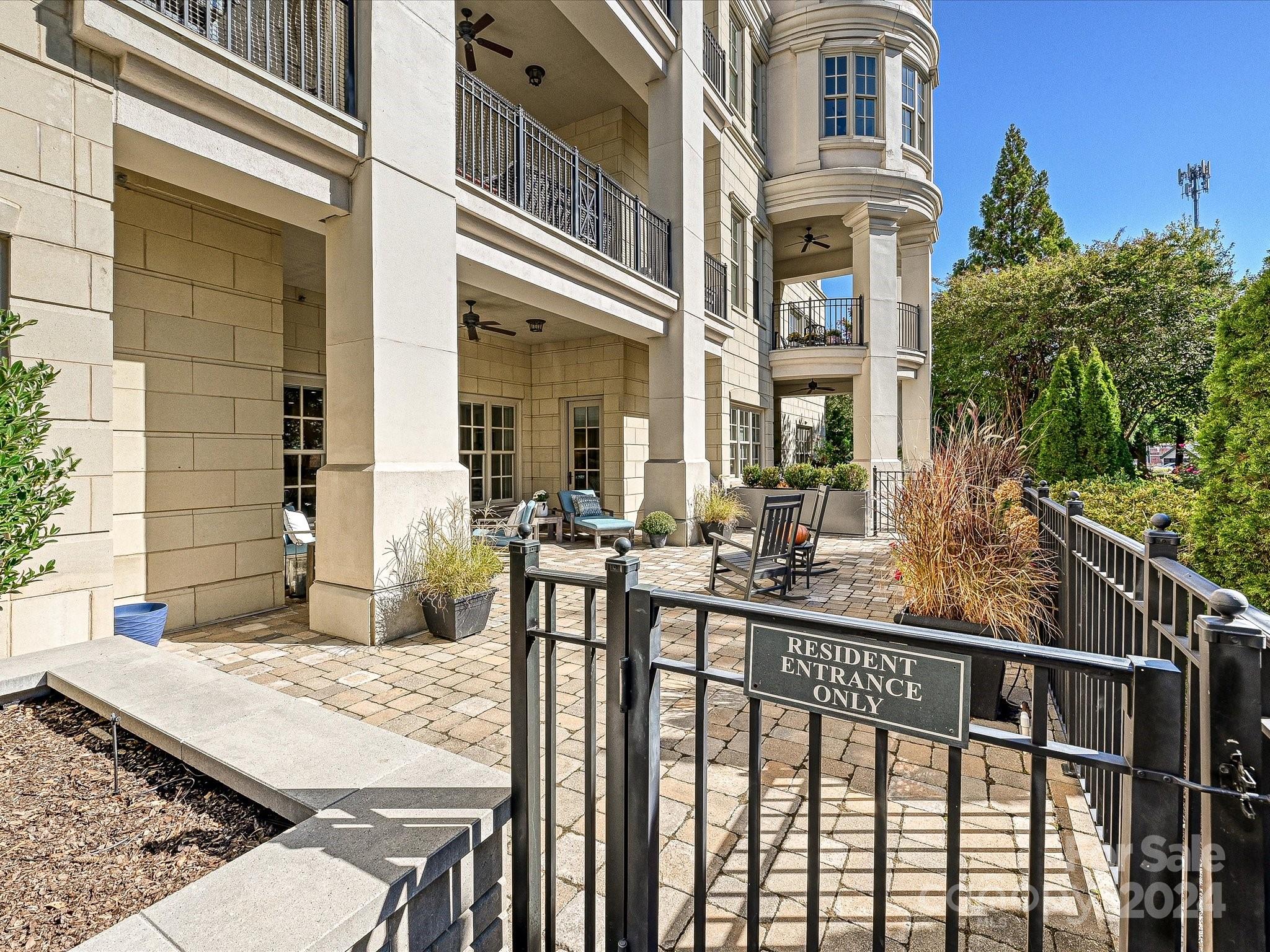 2823 Providence Road, Unit 216 Charlotte, NC 28211 - Photo 29 of 35 a view of a brick house with large windows and a table and chairs