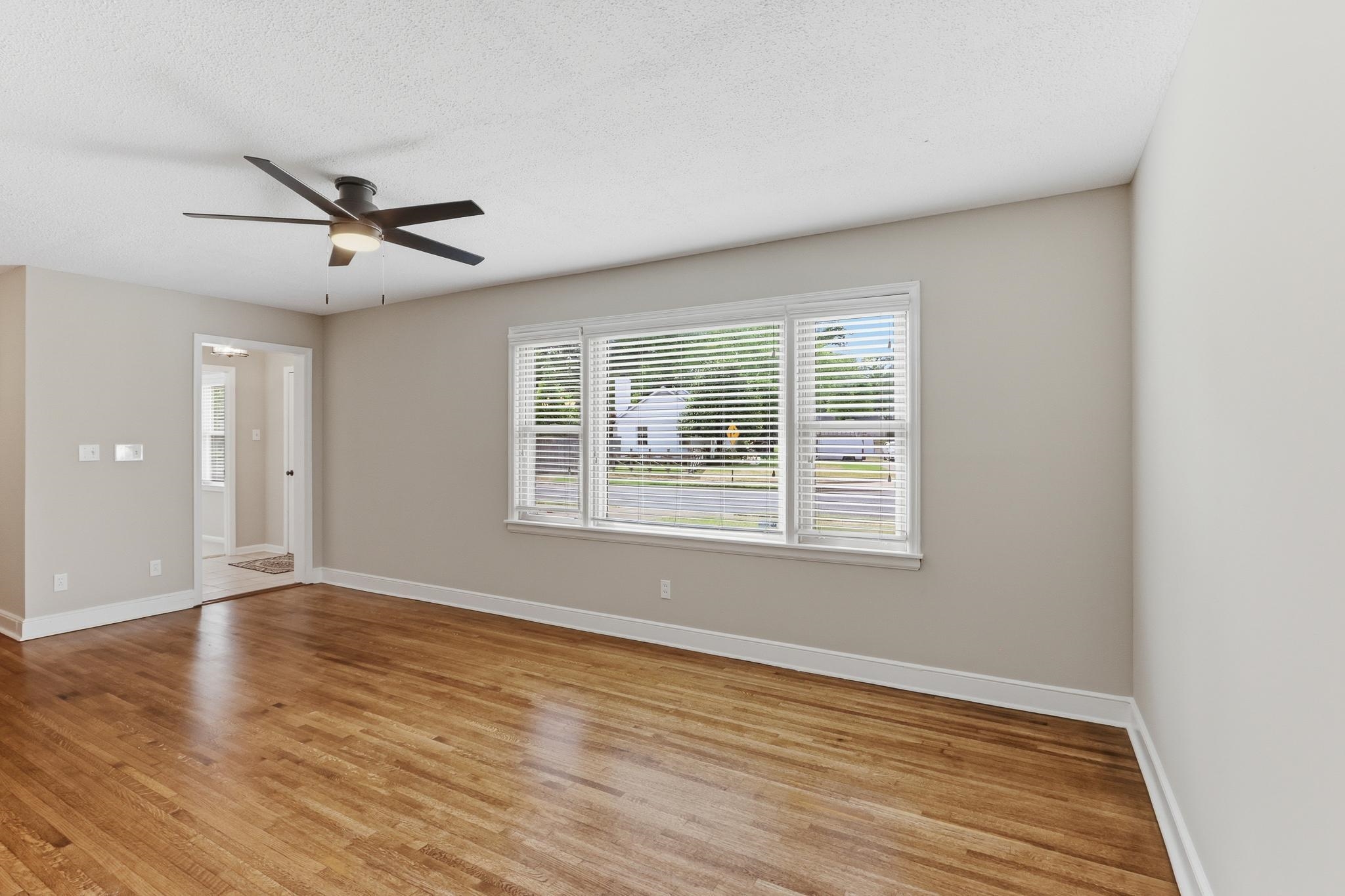 312 Fernway Road Memphis, TN 38117 - Photo 24 of 38 Spare room featuring light wood-style flooring, a ceiling fan, and a textured ceiling