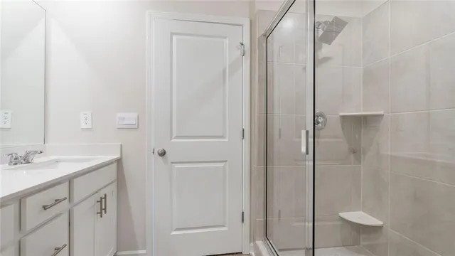 a bathroom with a shower and a sink