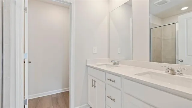 a bathroom with a double vanity sink and a mirror