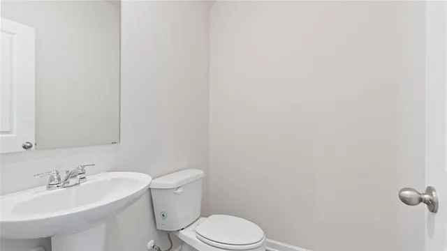 a bathroom with a sink a toilet and mirror
