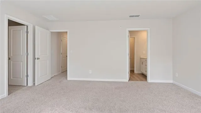 a view of an empty room and closet area