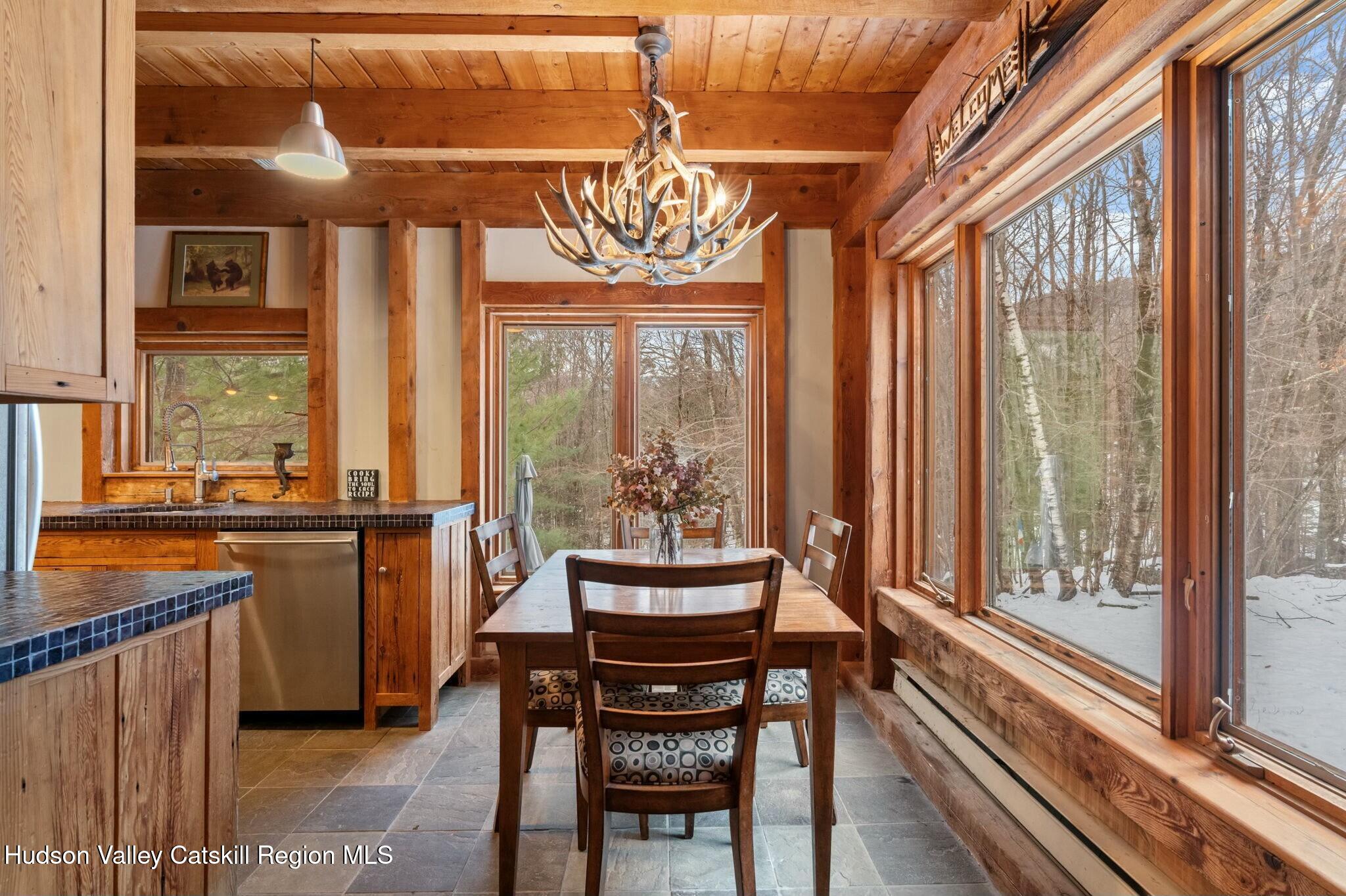 250 Macdaniel Road Woodstock, NY 12498 - Photo 13 of 39 a view of a dining room with furniture window and outside view