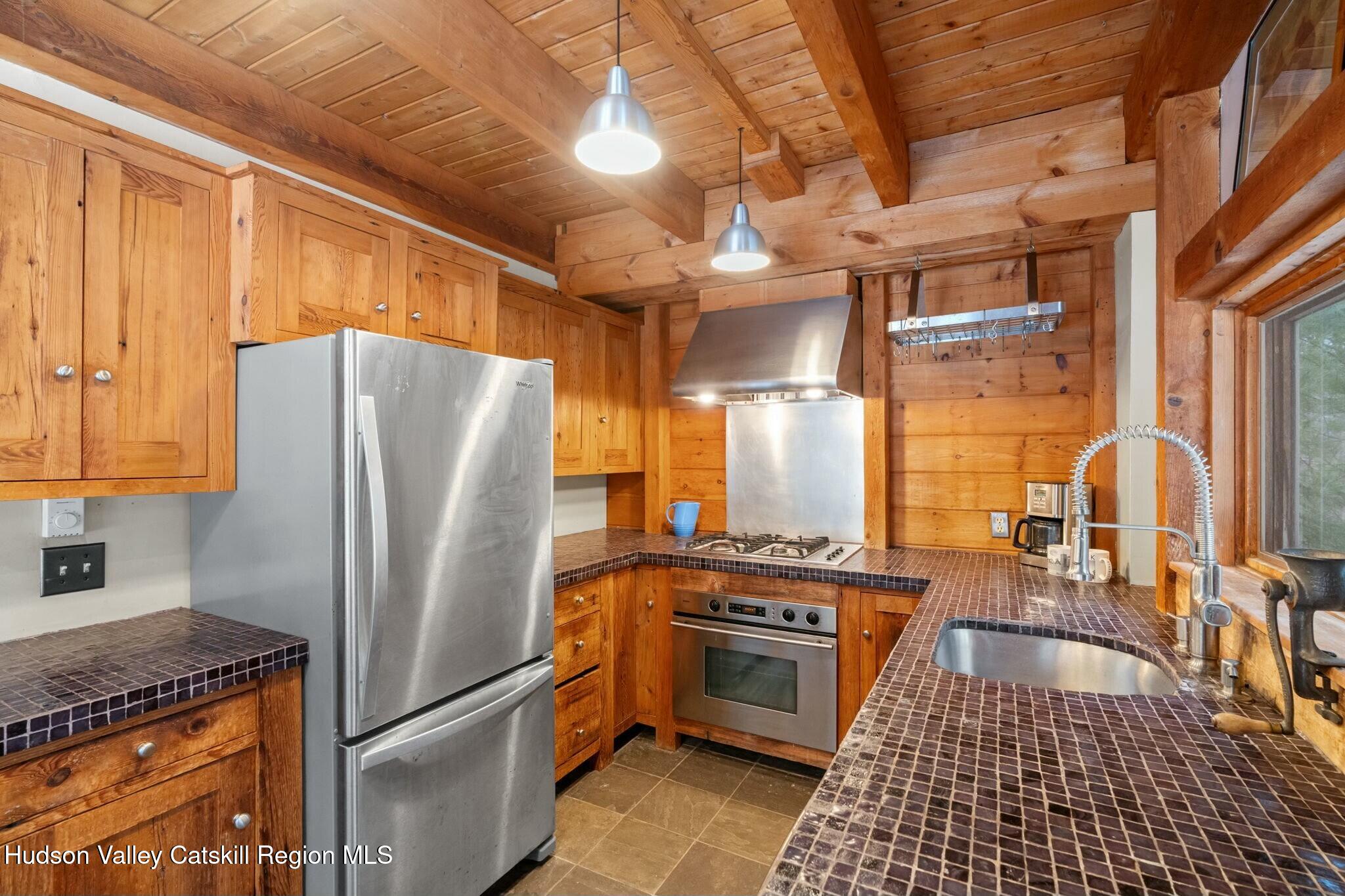 250 Macdaniel Road Woodstock, NY 12498 - Photo 16 of 39 a kitchen with granite countertop a refrigerator and a stove