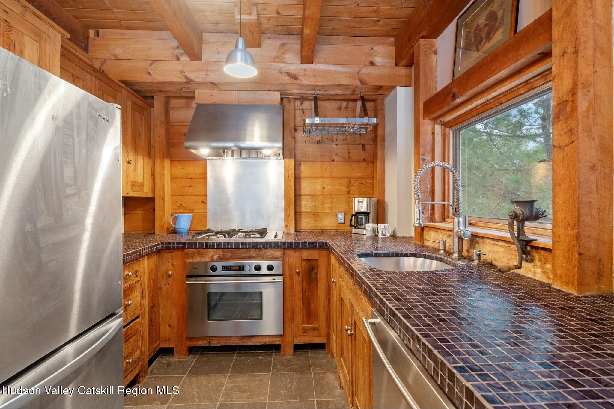 250 Macdaniel Road Woodstock, NY 12498 - Photo 17 of 39 a kitchen with a stove and wooden floor