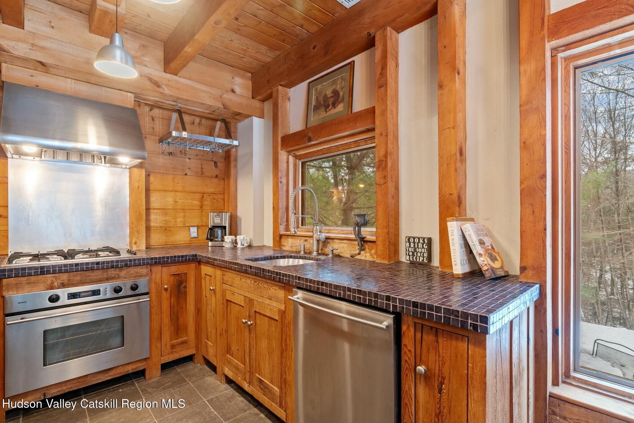 250 Macdaniel Road Woodstock, NY 12498 - Photo 18 of 39 a kitchen with stainless steel appliances granite countertop a stove and a sink